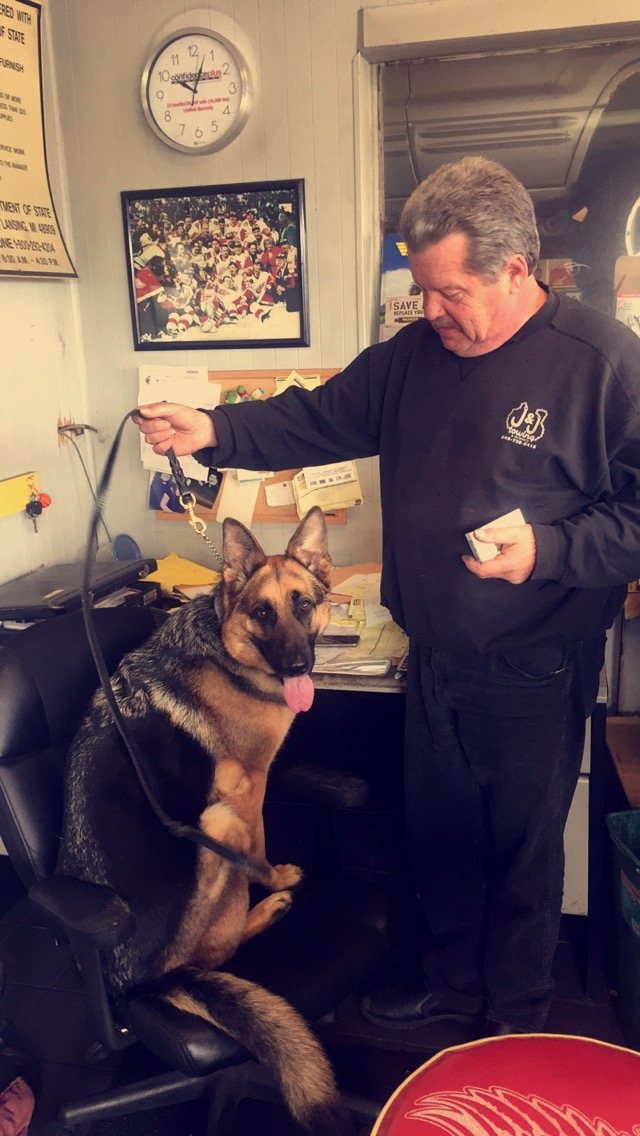 Brian with his German shepherd in the shop